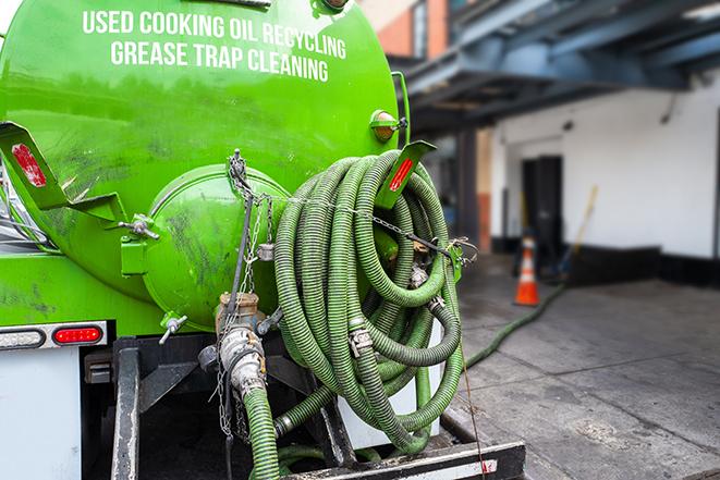 large truck pumping grease trap at a restaurant in Chester, GA